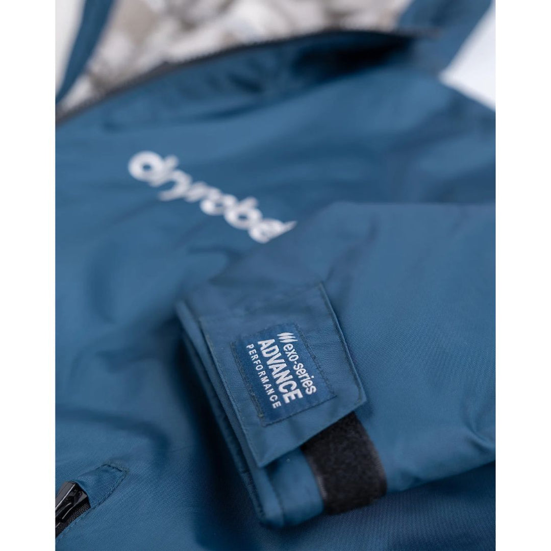 Close-up of a blue jacket with a brand logo on a white background