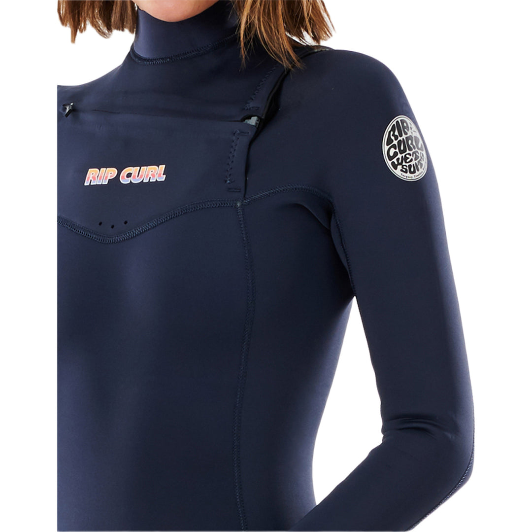 Close up of a woman wearing a navy blue chest zip Rip Curl Dawn Patrol Performance 5/4mm womens wetsuit with long sleeves and a high neck.